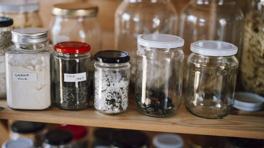 Organized kitchen pantry shelf with jars and dry food containers