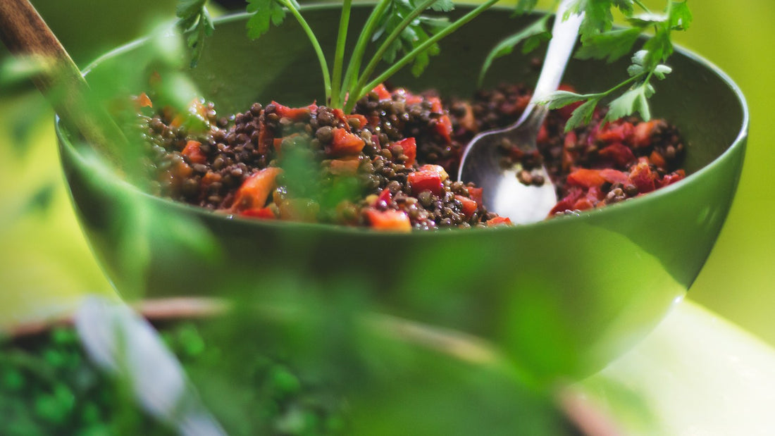 A lentil and vegetable lunch bowl with fresh herbs