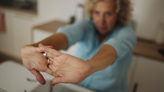 A person doing a gentle desk stretch during a simple afternoon reset