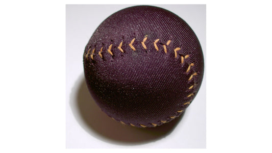 Plain dark fabric-covered soft ball with tan stitching on a light background