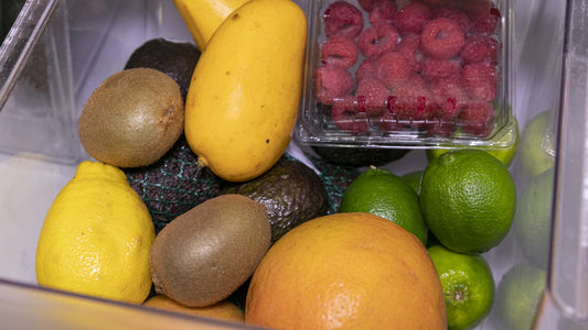 Fruit arranged in an open refrigerator produce drawer
