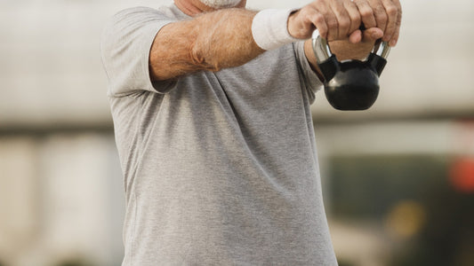 A person strength training with dumbbells as part of a steady pro-aging routine