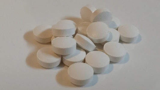Supplement pills arranged on a neutral background as part of a simple daily wellness routine.