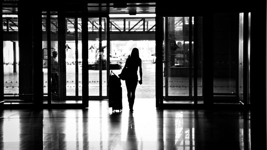 Traveler with a suitcase in a transit terminal for a simple travel-day wellness routine